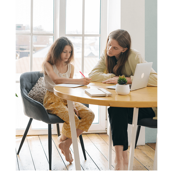 Mother helping daughter with homework in homeschool curriculum