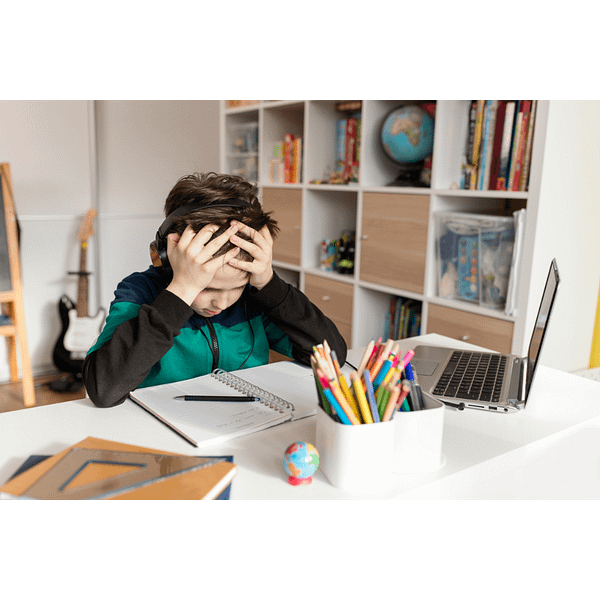 Boy with headphones frustrated with writing in his homeschool curriculum